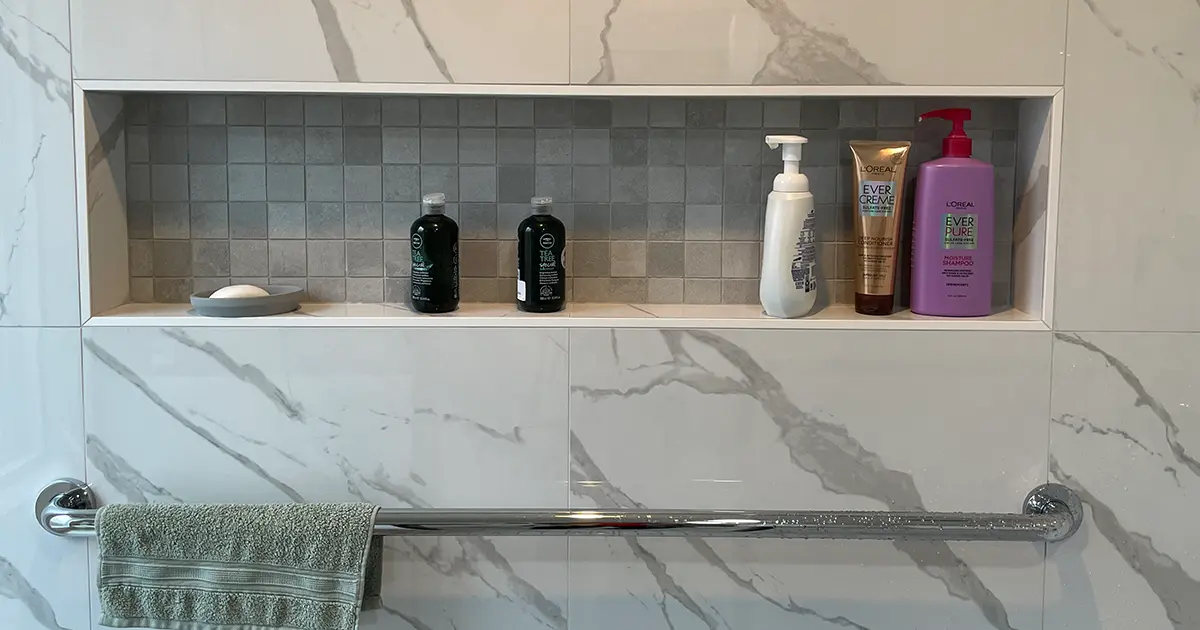 Luxury marble shower niche with built-in storage and modern bathroom tile renovation design