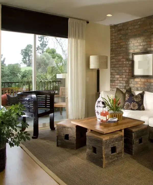 Home addition with spacious living room, brick accent wall, and large sliding glass doors