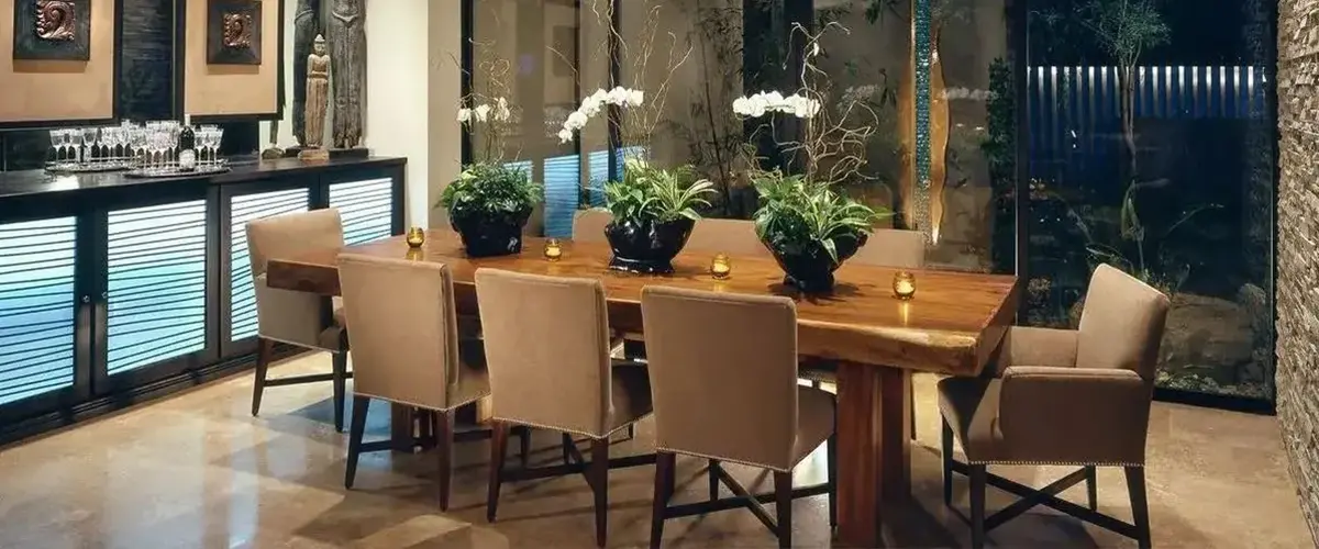 Luxury home addition featuring a custom dining room with wood table and floor-to-ceiling windows